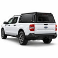 A white Ford maverick pickup truck shown from a rear three-quarter angle, fitted with a black Gullwing Caps aerowing truck canopy, set against a plain white studio background.
