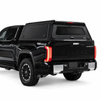 truck canopy with smooth and flat gullwing side doors on a toyota tundra pickup truck